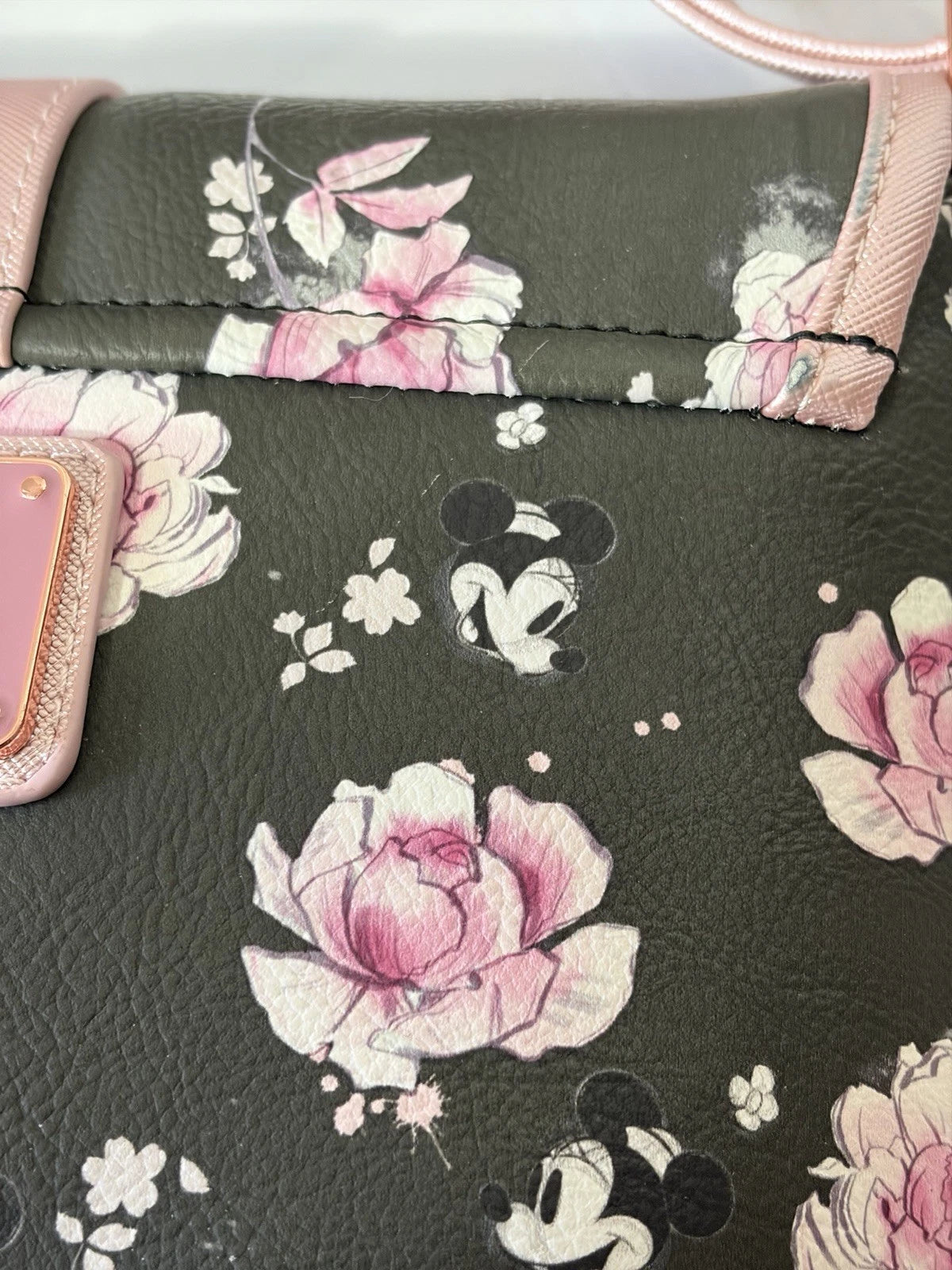 Loungefly x Disney Positively Minnie Collection Saddle Bag. Black Pink Floral close up of pink flowers and Minnie Mouse pattern on a textured black background. 